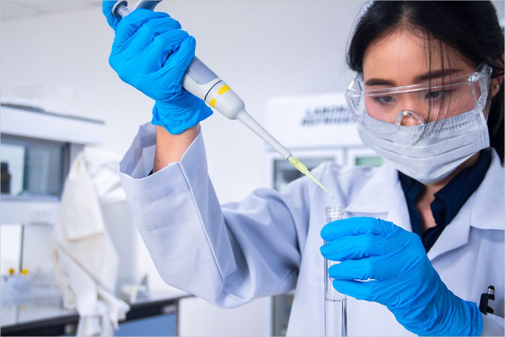 Frau im Labor mit Pipette